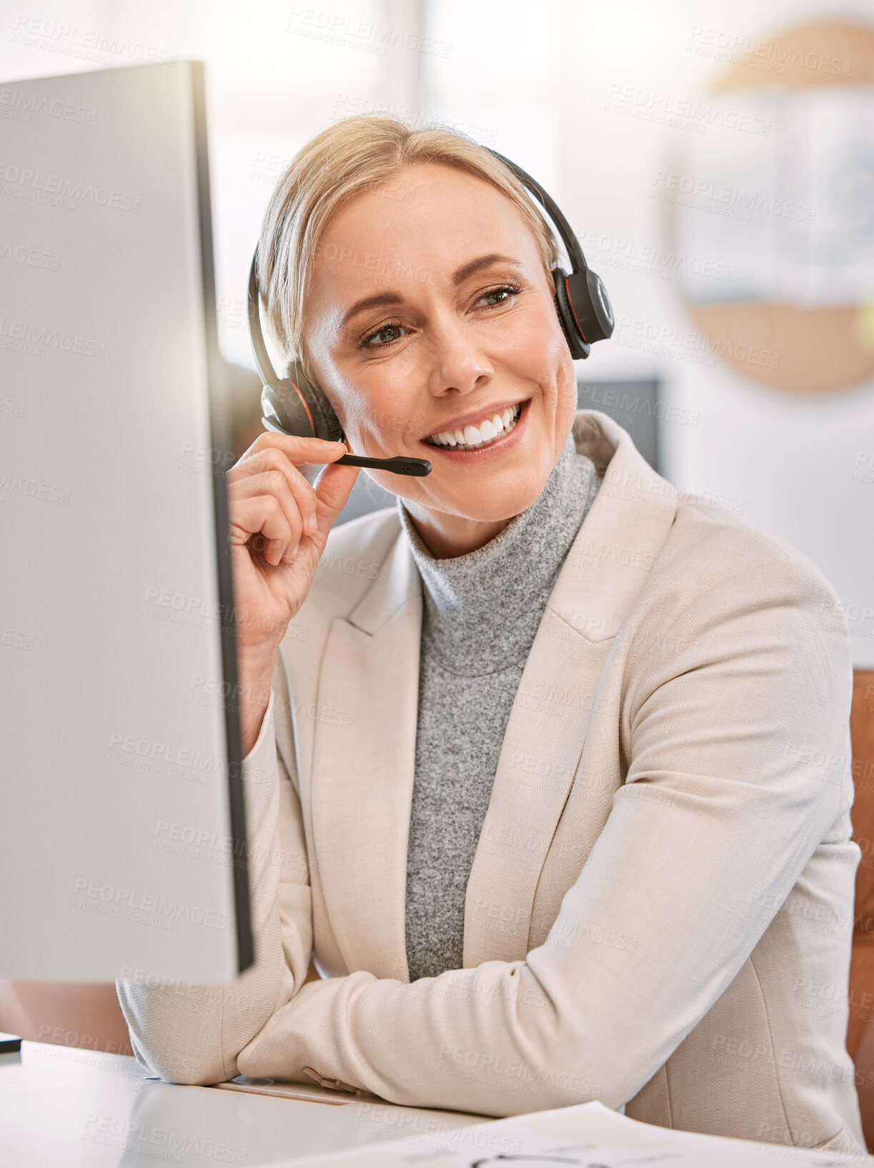 Buy stock photo Cropped shot of an attractive mature female call center agent wearing a headset while working in her office