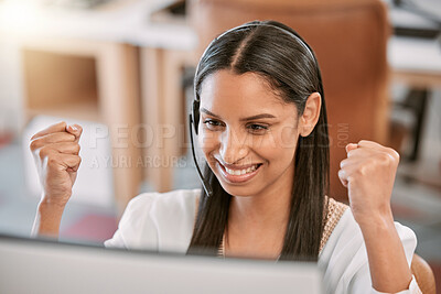 Buy stock photo Cropped shot of an attractive young call center agent wearing a headset and cheering while working on her computer in the office