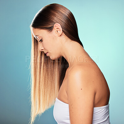 Buy stock photo Studio shot of an attractive young woman posing against a blue background