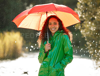 Buy stock photo Shot of a beautiful young woman spending a day outside in the rain