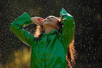 Buy stock photo Shot of a beautiful young woman having fun in the rain