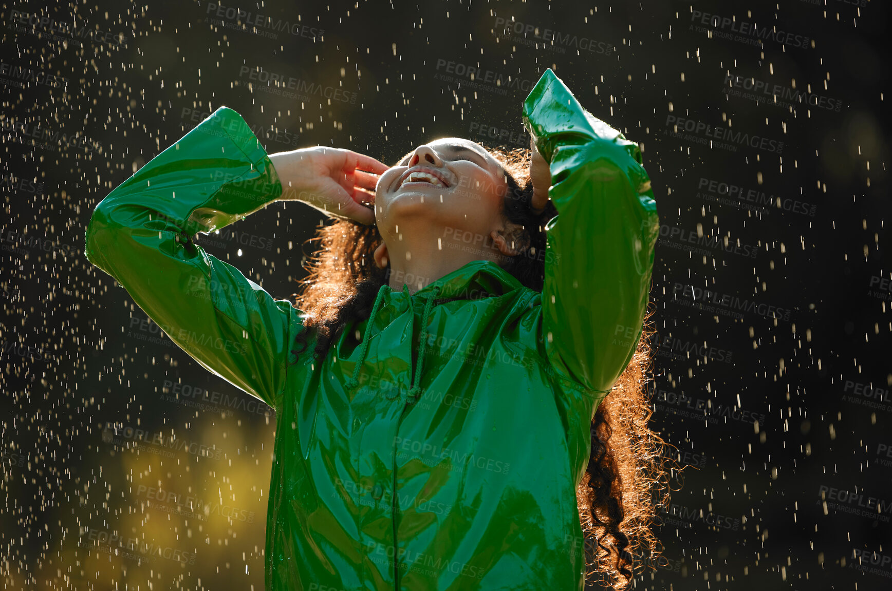 Buy stock photo Shot of a beautiful young woman having fun in the rain