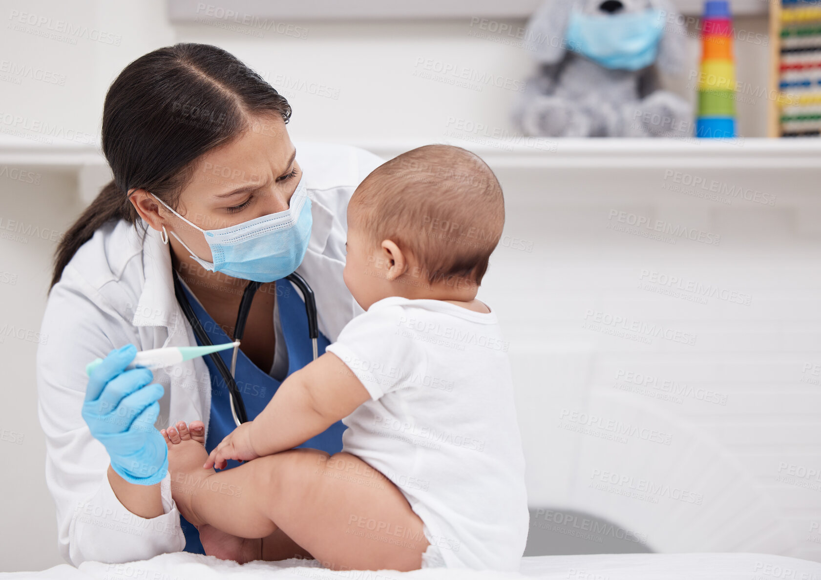 Buy stock photo Shot of a doctor giving medicine to a baby in a hospital