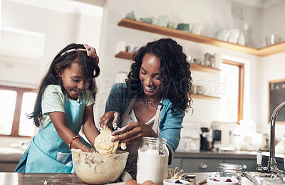 Buy stock photo Shot of a woman baking at home with her young daughter