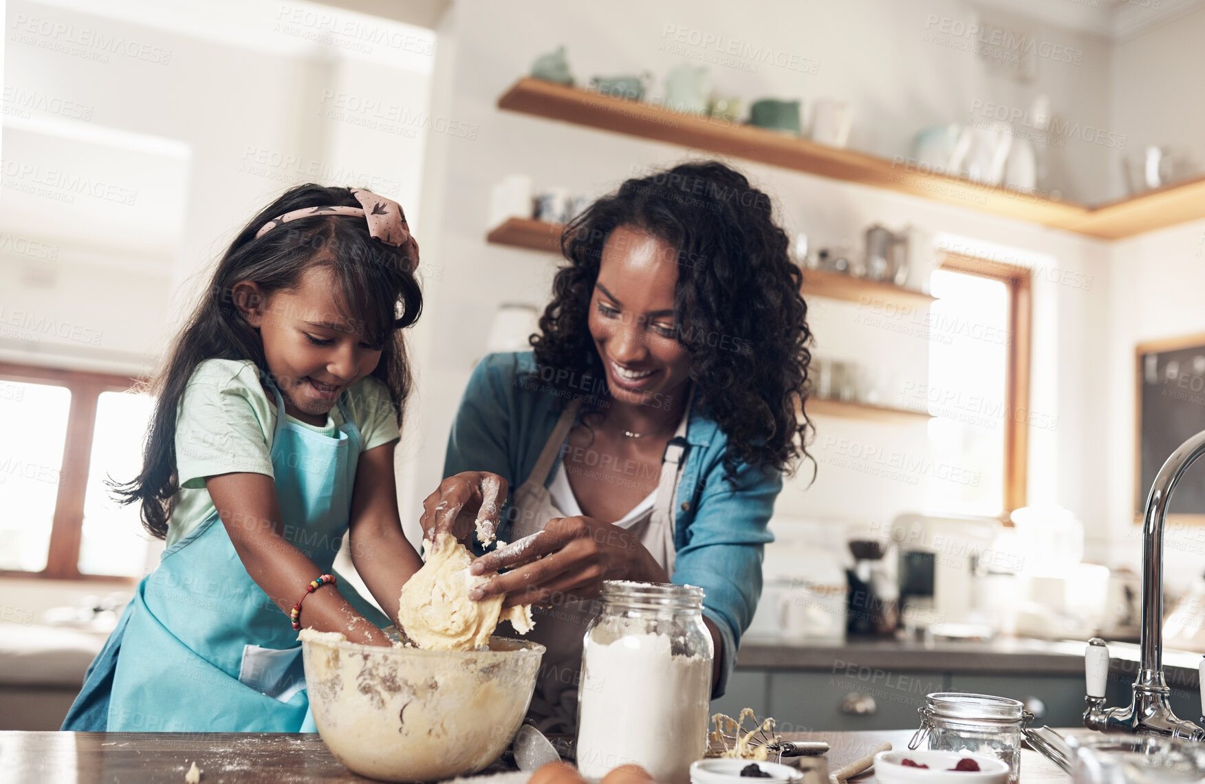 Buy stock photo Shot of a woman baking at home with her young daughter