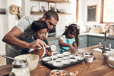 Buy stock photo Shot of a father teaching his children how to bake in the kitchen at home