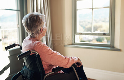 Buy stock photo Shot of a senior woman in a wheelchair looking thoughtfully out of a window at home