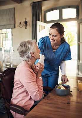 Buy stock photo Shot of a young nurse checking up on a senior woman during breakfast at a nursing home