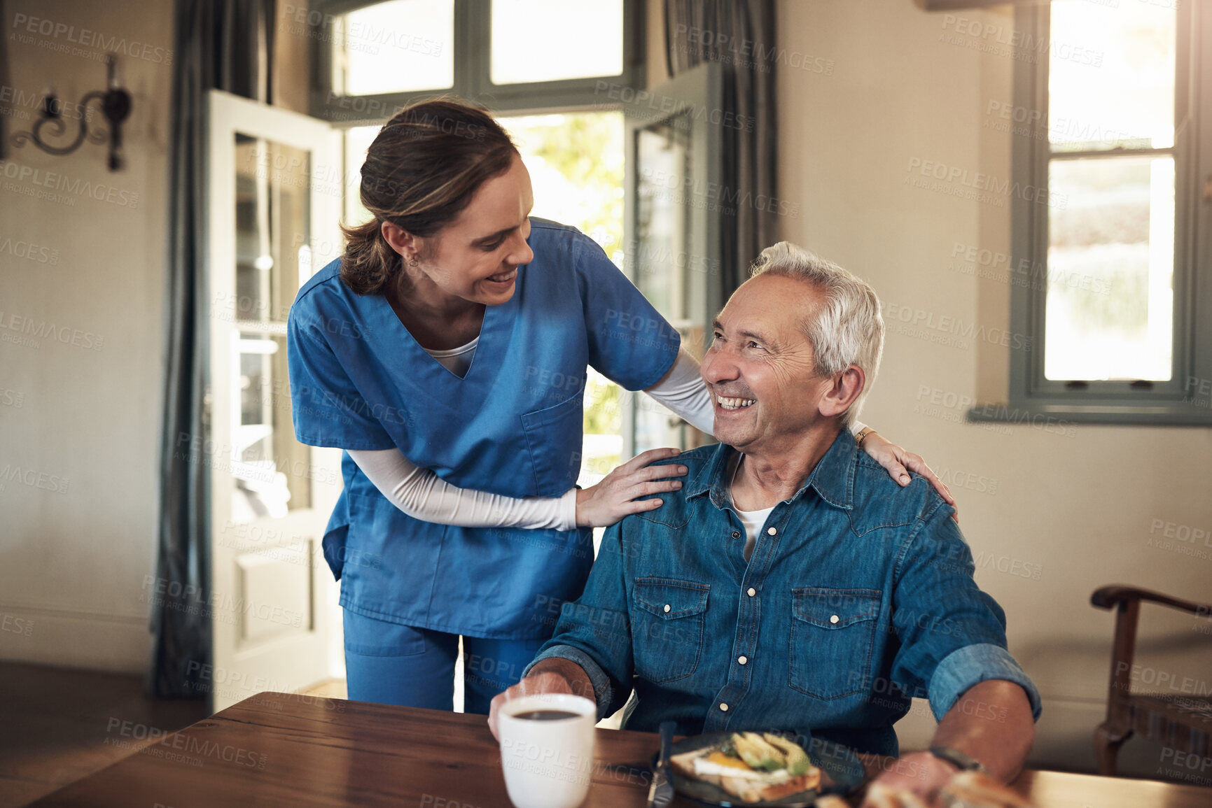 Buy stock photo Shot of a young nurse checking up on a senior man during breakfast at a nursing home