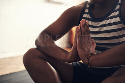 Buy stock photo Closeup shot of an unrecognisable man meditating at home