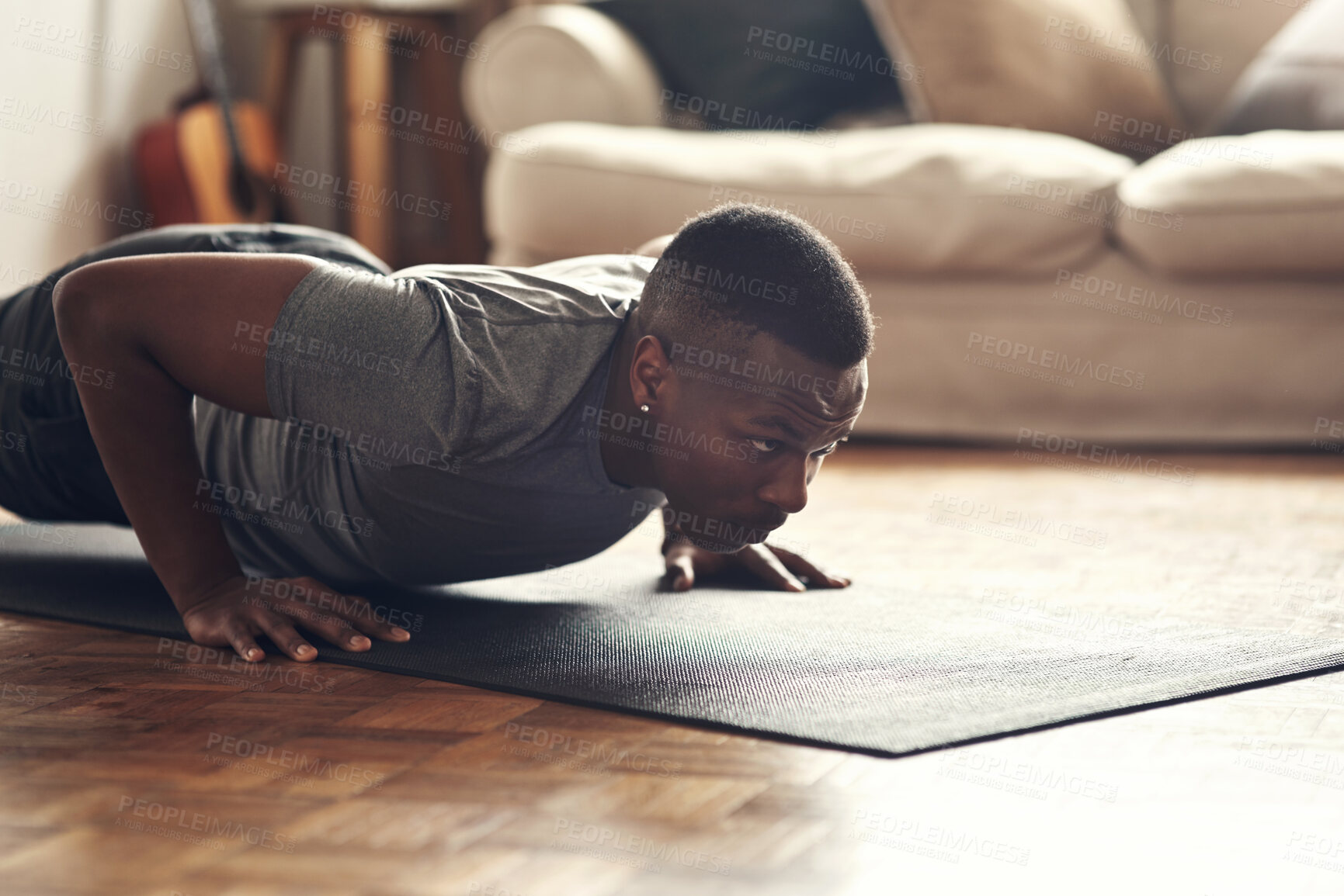 Buy stock photo Black man, push ups and exercise with mat for fitness, workout or gym practice on floor at home. Young African, male person or lifting body weight for endurance, strength or muscle gain in training