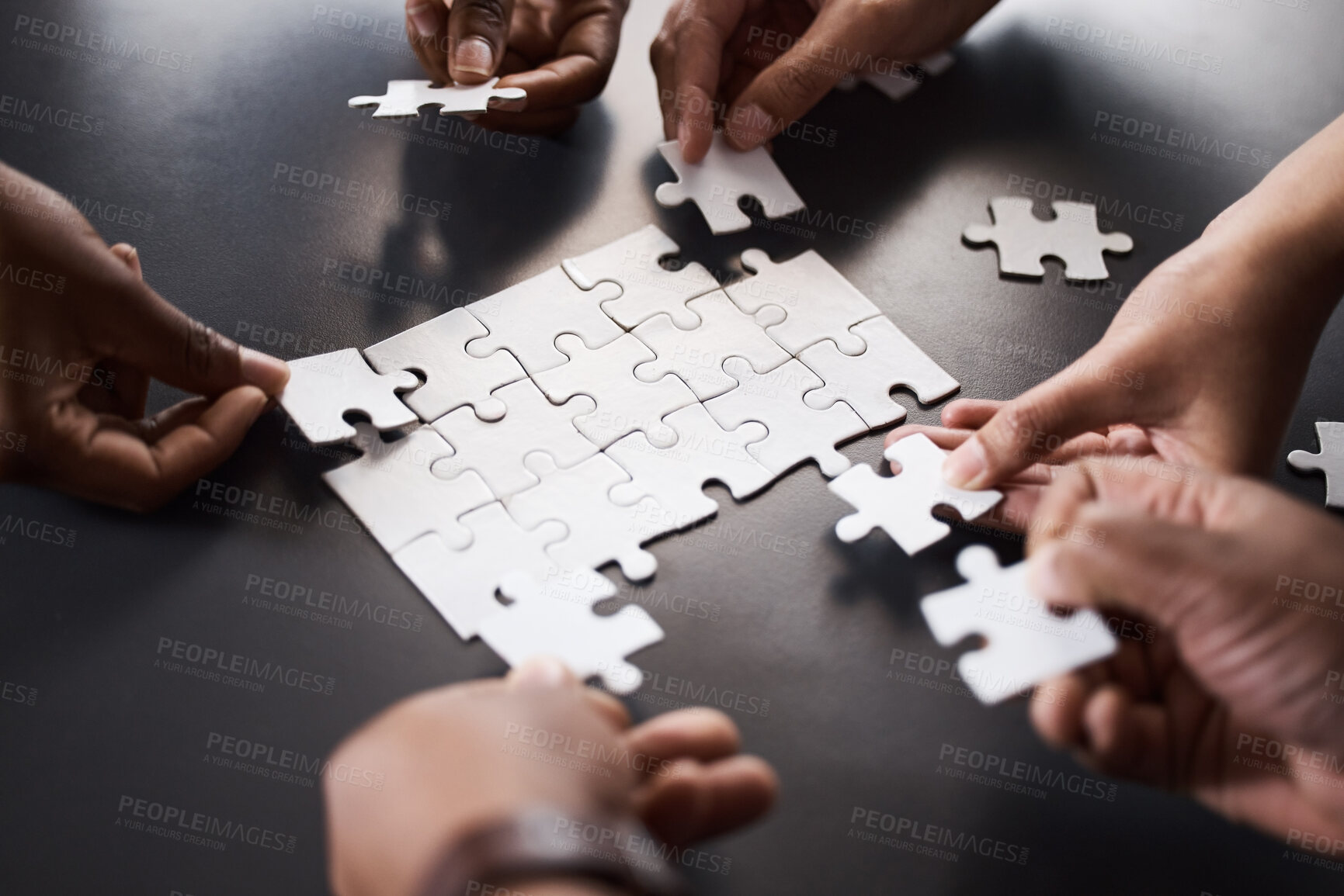 Buy stock photo Puzzle, hands and people with pieces, table and unity of employees, planning and teamwork for strategy. Above, collaboration and group of colleagues in business, solidarity and working with synergy
