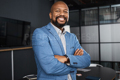 Buy stock photo Portrait of a confident mature businessman standing with his arms crossed in an office