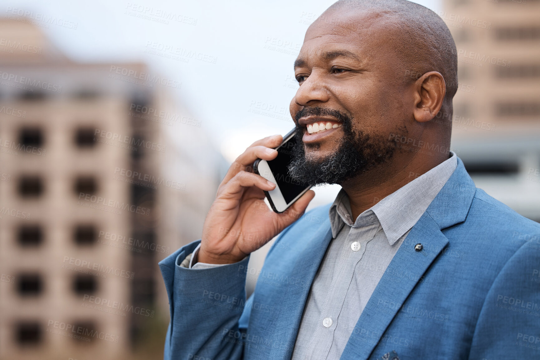 Buy stock photo Shot of a mature businessman talking on a cellphone while standing on a balcony outside an office