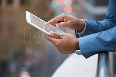 Buy stock photo Closeup shot of an unrecognisable businessman using a digital tablet while standing on a balcony outside an office