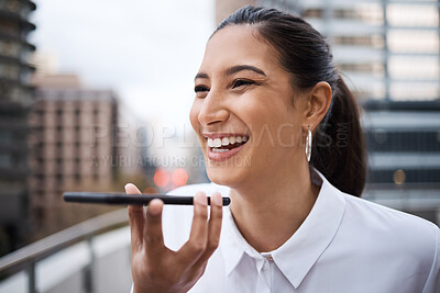 Buy stock photo Shot of a young businesswoman using a cellphone while standing on a balcony outside an office