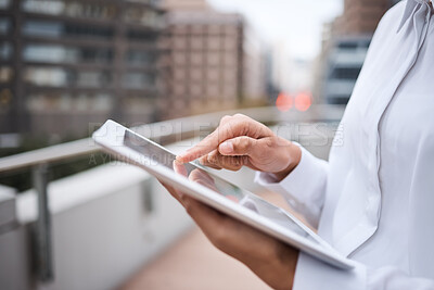 Buy stock photo Closeup shot of an unrecognisable businesswoman using a digital tablet outside an office