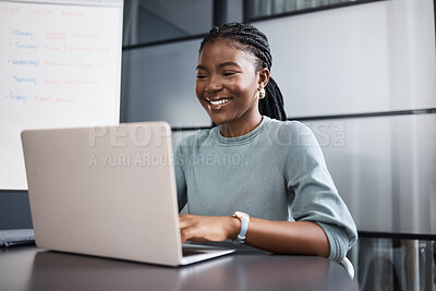 Buy stock photo Shot of a young businesswoman working on a laptop in an office