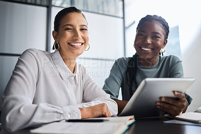 Buy stock photo Portrait of two businesswomen working together on a digital tablet in an office