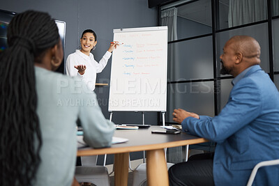 Buy stock photo Shot of a young businesswoman using a whiteboard during a presentation to her colleagues in an office