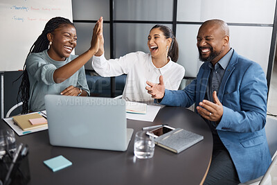 Buy stock photo Shot of a group of businesspeople cheering while using a laptop together in an office