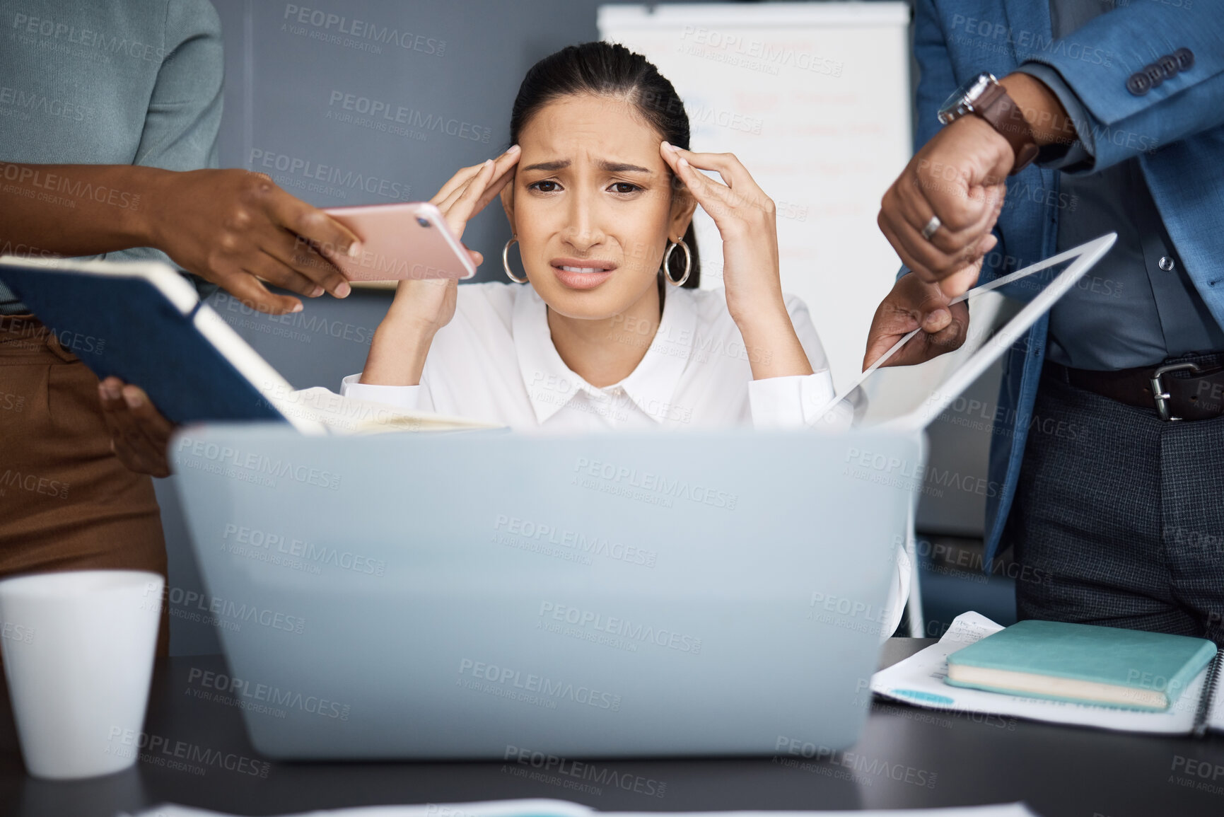 Buy stock photo Shot of a young businesswoman looking stressed out in a demanding office environment