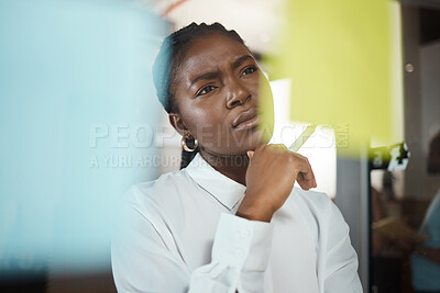 Buy stock photo Shot of a businesswoman brainstorming with sticky notes on a glass screen