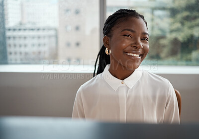Buy stock photo Shot of a confident young businesswoman sitting at her desk