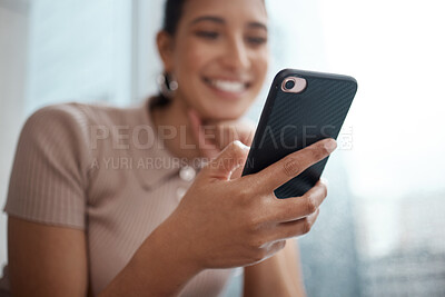 Buy stock photo Shot of a young businesswoman using her cellphone at the office