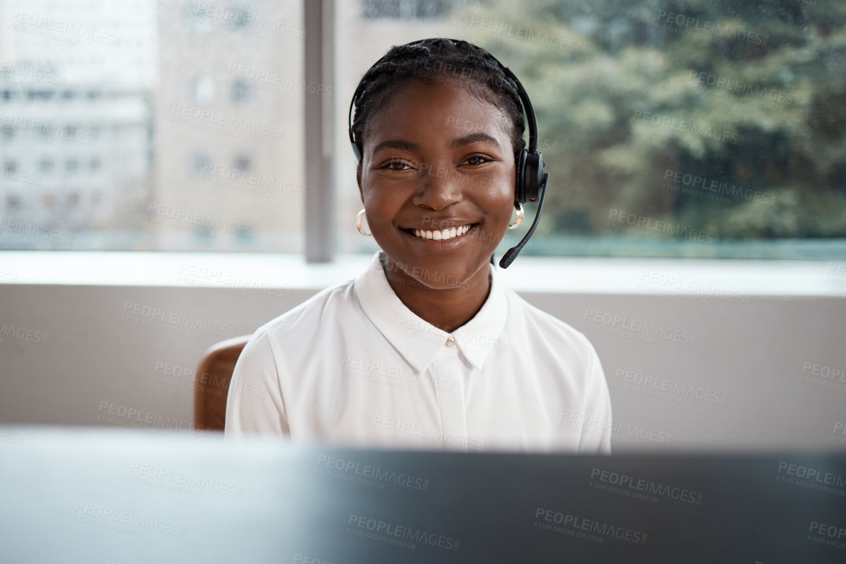 Buy stock photo Shot of a call center agent working at her desk