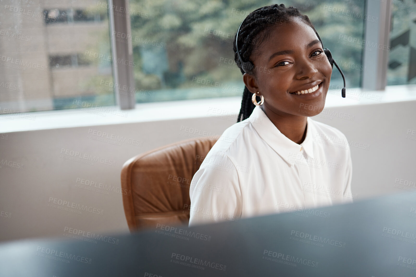 Buy stock photo Shot of a call center agent working at her desk
