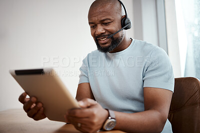 Buy stock photo Shot of a man using a digital tablet while working in a call center