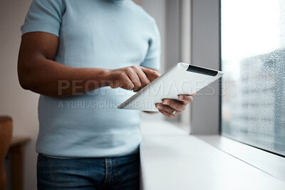 Buy stock photo Cropped shot of an unrecognisable businessman using a digital tablet