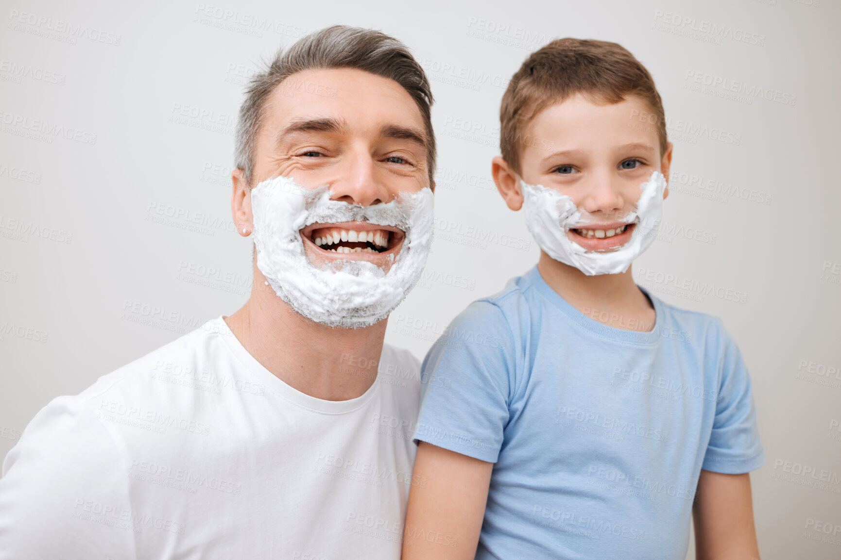 Buy stock photo Cropped portrait of a handsome mature man teaching his young son how to shave in the bathroom at home