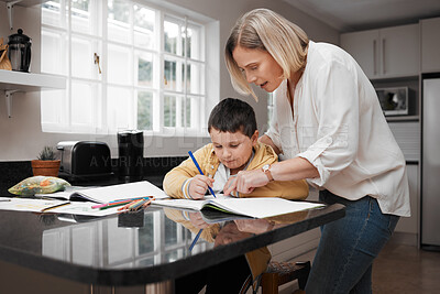 Buy stock photo Shot of a beautiful mother helping her son with his homework