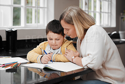 Buy stock photo Shot of a mother and her son completing school work at home