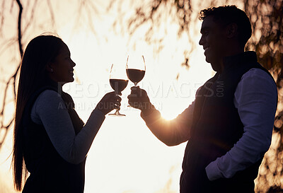 Buy stock photo Shot of a young couple enjoying a glass of wine while camping