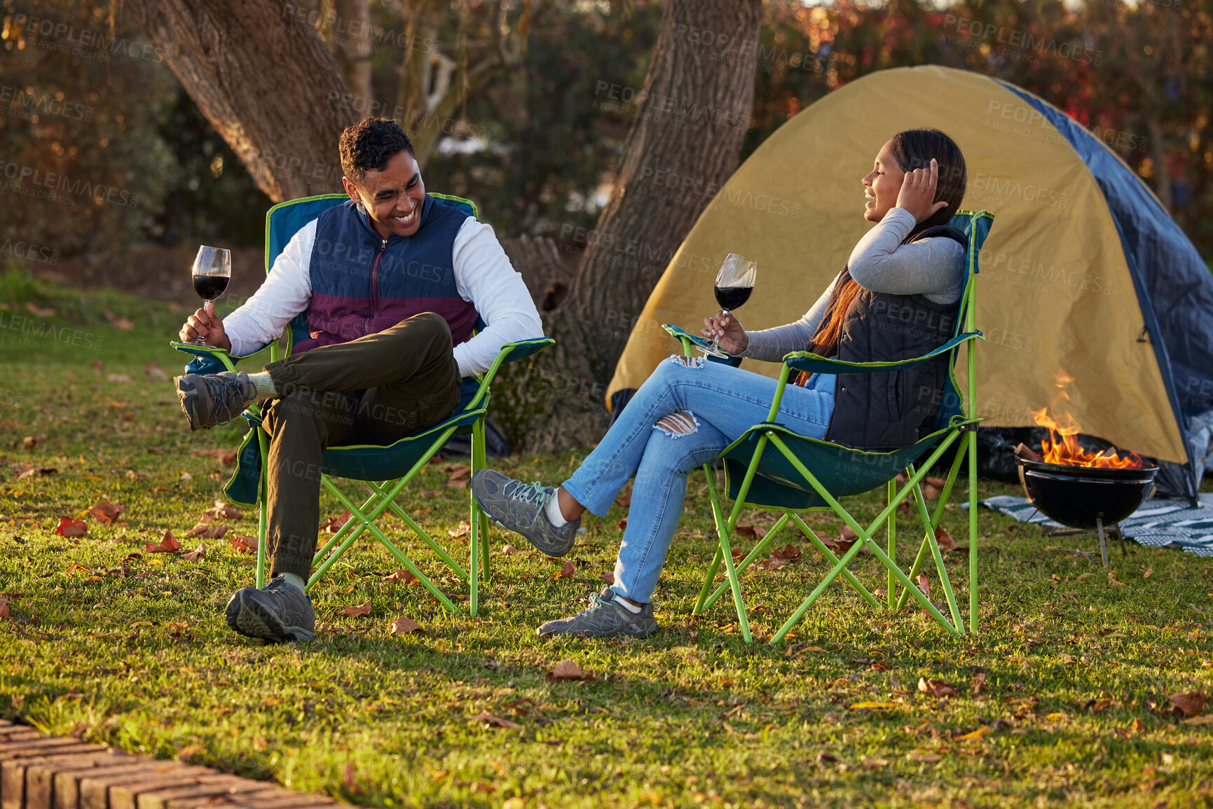 Buy stock photo Happy, couple and wine by camping in outdoor to celebrate anniversary with love or bonding together. Smile, man and woman on adventure in nature to relax with alcohol for valentines day on vacation