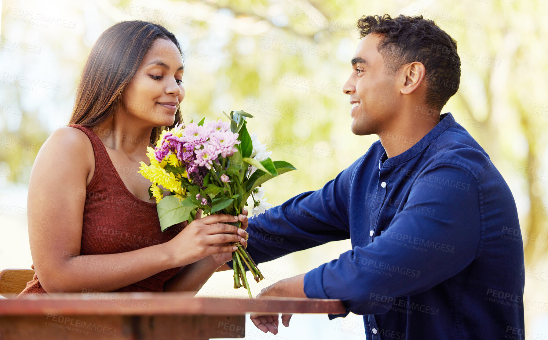 Buy stock photo Man, woman and bouquet at restaurant, outdoor and happy with present, love and romance in summer. Couple, date and smell flowers for gift with smile, care and connection on holiday in countryside