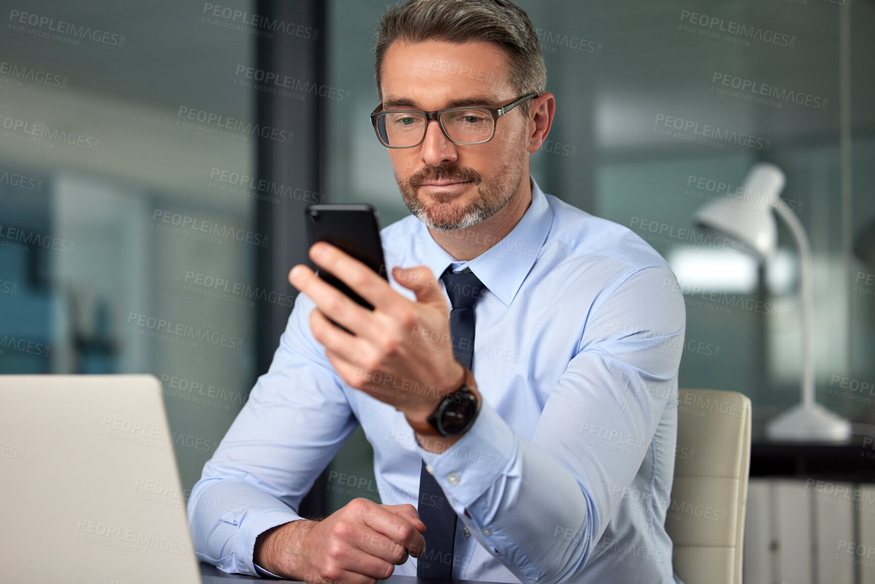 Buy stock photo Business man, phone and boss at a office with networking online at a company. Reading, scrolling and male person at desk with mobile management and communication at a workplace with social media