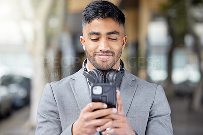 Buy stock photo Business man, phone and city of a professional with headphones watching a video. Urban, smile and Indian male person with work travel, mobile streaming and happiness with cellphone app and web
