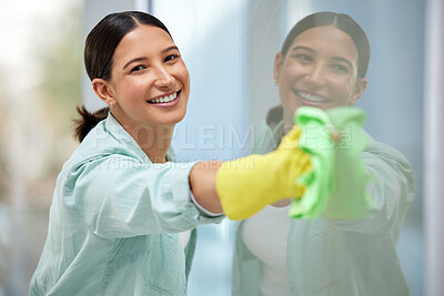 Buy stock photo Shot of a beautiful young woman cleaning her home windows