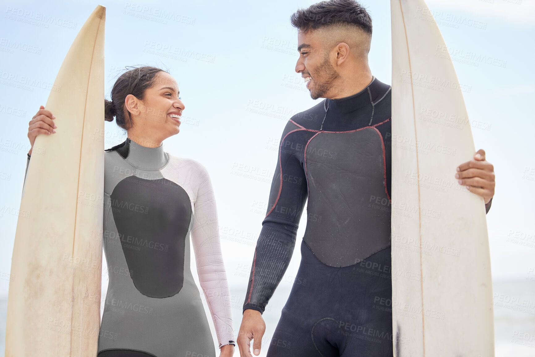 Buy stock photo Happy, couple and love by beach with surfboard for training or workout for competition, adventure and water sport. Surfers, beachwear and board for active fitness by ocean coast in California