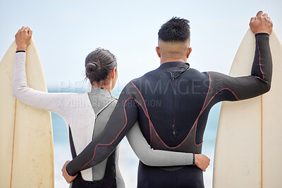 Buy stock photo Hugging, couple and surfboard on beach with swimwear, together and watching waves for wellness, exercise and bonding. Vacation, lovers and waiting for surf on shore for fitness, sport and cardio