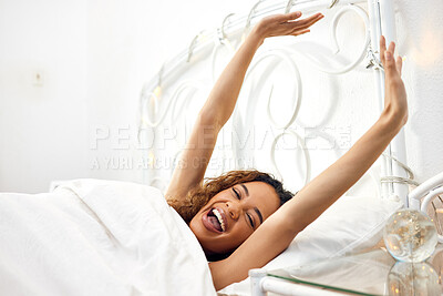 Buy stock photo Shot of an attractive young woman lying in her bed and stretching in the morning at home