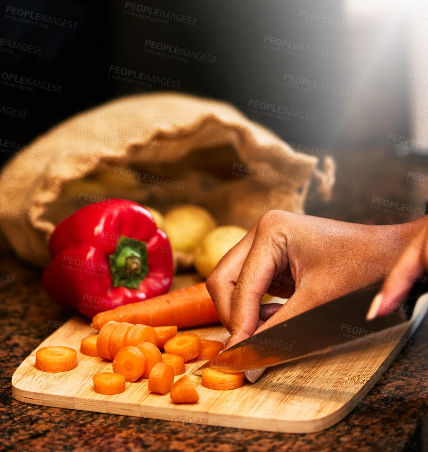 Buy stock photo Shot of a woman chopping vegetables in preparation for a meal