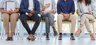 Buy stock photo Closeup shot of a group of businesspeople sitting in line in an office