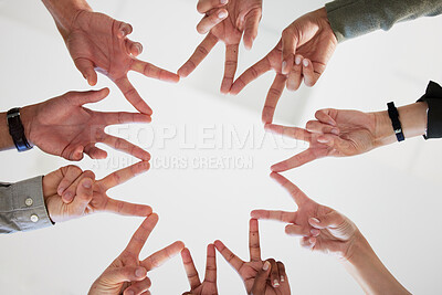 Buy stock photo Below shot of a group of unrecognizable businesspeople joining their hands against a white background