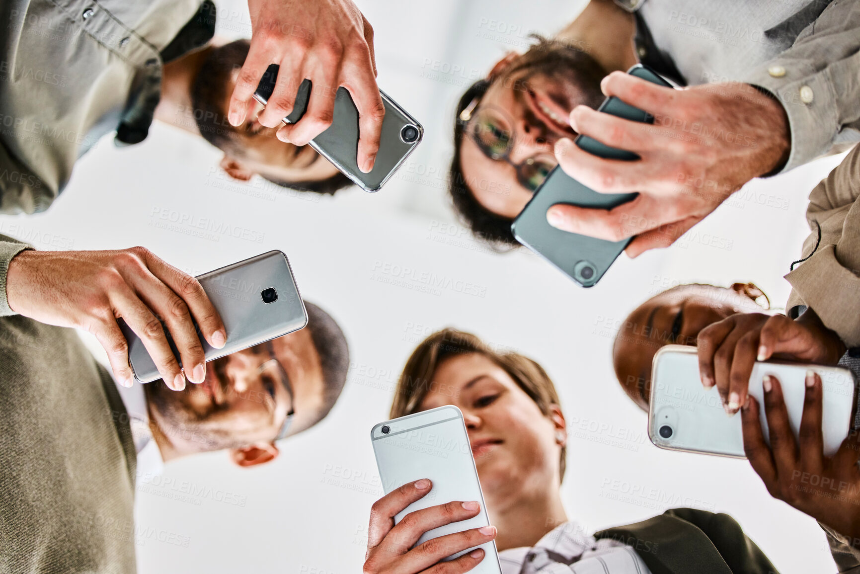 Buy stock photo Business, people and low angle with smartphone in hands, networking and together in creative career with social media. Data syncing, information tech and employees, schedule sharing or communication