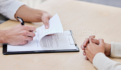 Buy stock photo Cropped shot of two unrecognizable businesspeople sitting together in the office and signing a contract